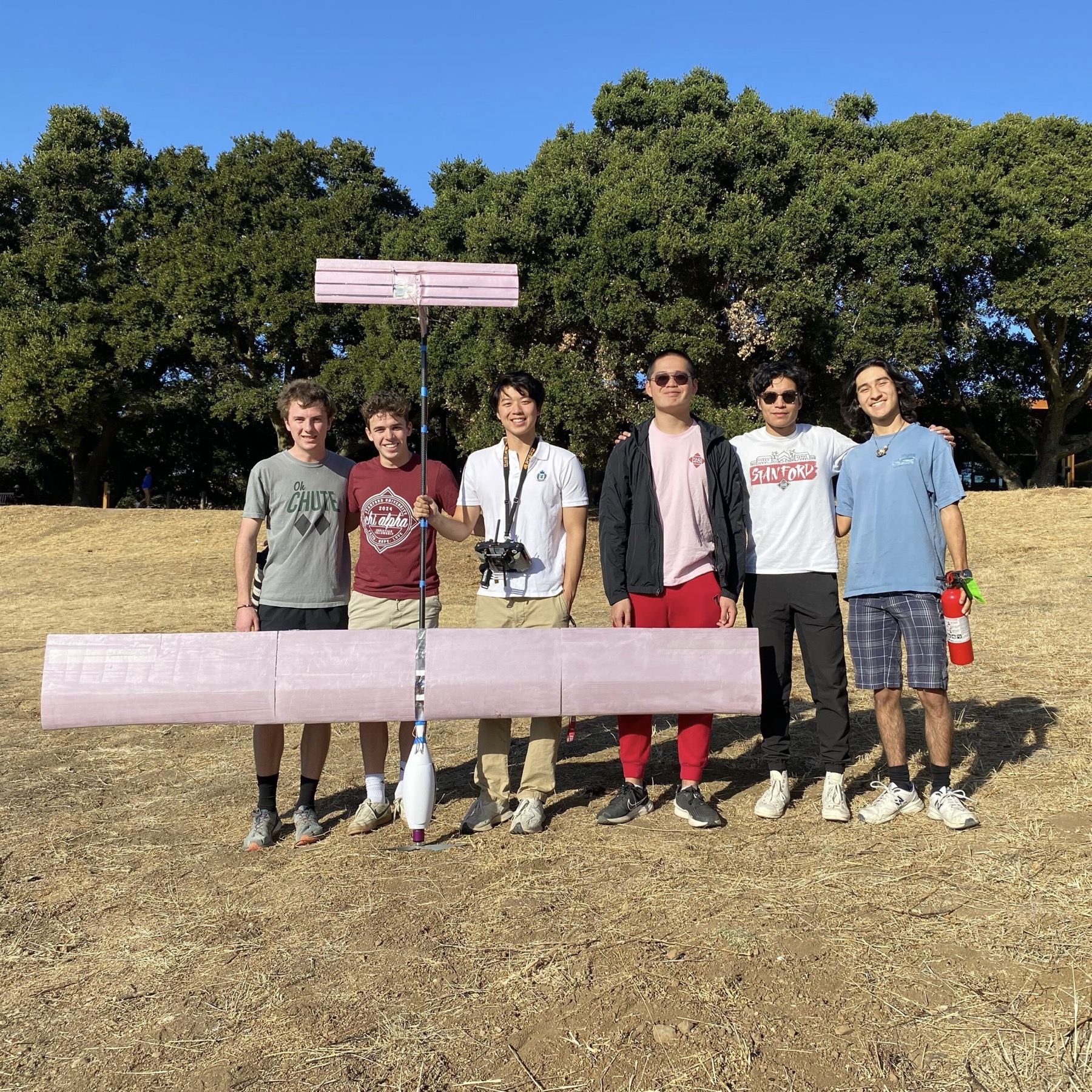 Stanford Swift team members standing behind the solar-plane prototype in their workshop