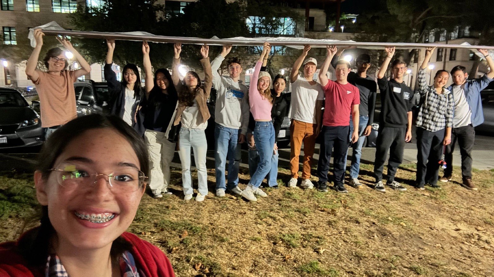 Stanford Swift team members holding a long composite wing section